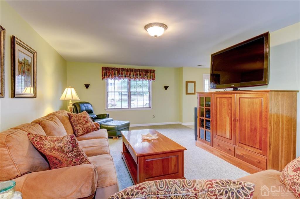 13 June Way Middlesex, NJ 08846 - Photo 11 of 22 a living room with furniture and a flat screen tv