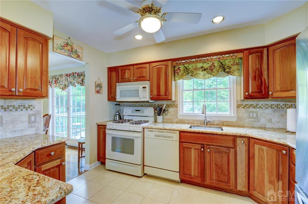 13 June Way Middlesex, NJ 08846 - Photo 3 of 22 a kitchen with stainless steel appliances granite countertop a stove sink and cabinets