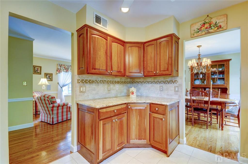 13 June Way Middlesex, NJ 08846 - Photo 10 of 22 a kitchen with stainless steel appliances granite countertop a table chairs and a refrigerator