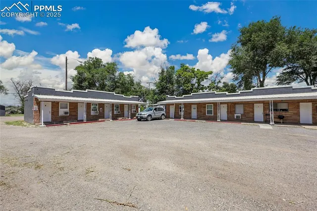 front view of a house with a large window and a yard