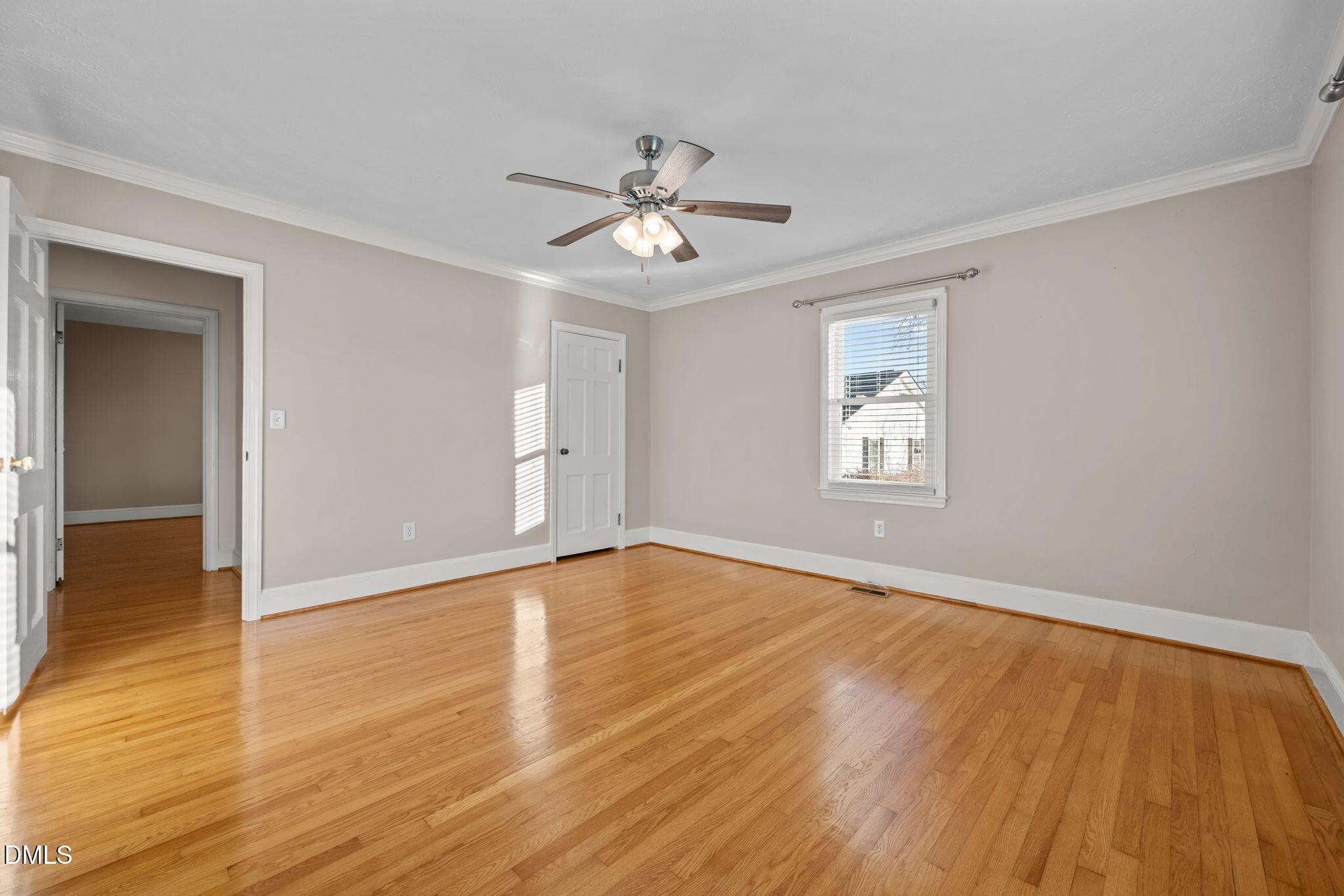 7111 Highway 401 Bunnlevel, NC 28323 - Photo 21 of 39 an empty room with wooden floor chandelier fan and windows