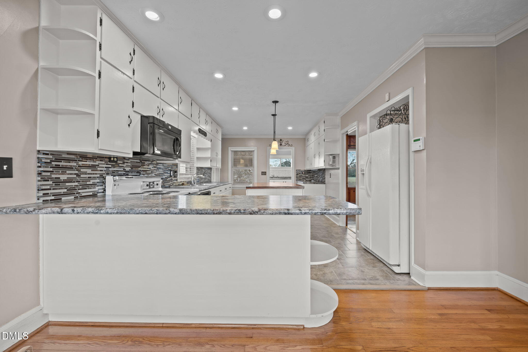 7111 Highway 401 Bunnlevel, NC 28323 - Photo 9 of 39 a view of kitchen with stainless steel appliances granite countertop refrigerator stove microwave and cabinets