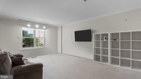 a living room with a flat screen tv and a window