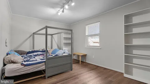 a bedroom with furniture and a window