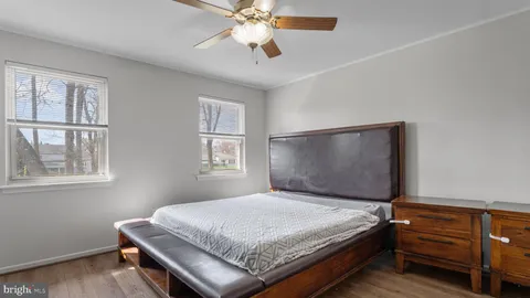 a bedroom with a bed table and window