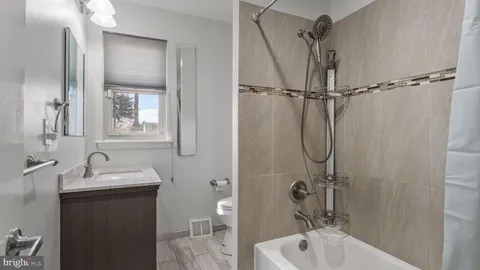 a bathroom with a sink and mirror with toilet