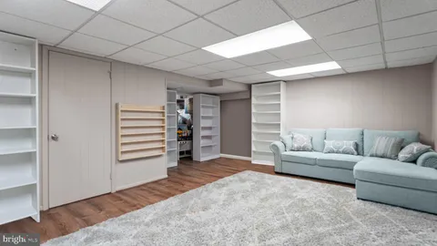 a living room with furniture and walk in closet