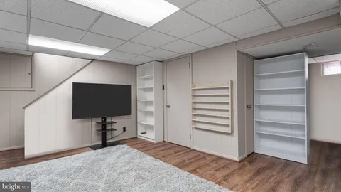 a view of room with wooden floor and flat screen tv