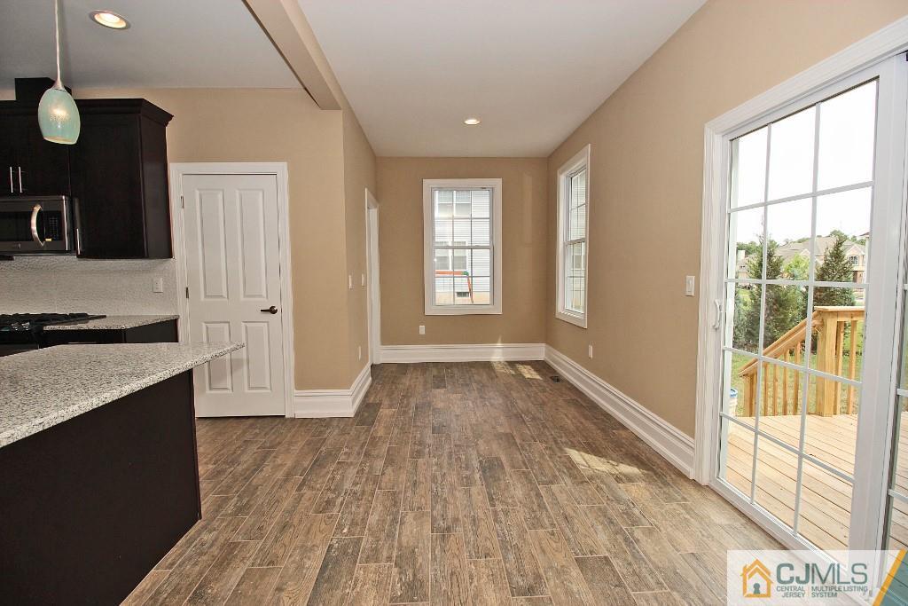 1035 New Durham Road Edison, NJ 08817 - Photo 13 of 24 a view of a kitchen with wooden floor and staircase