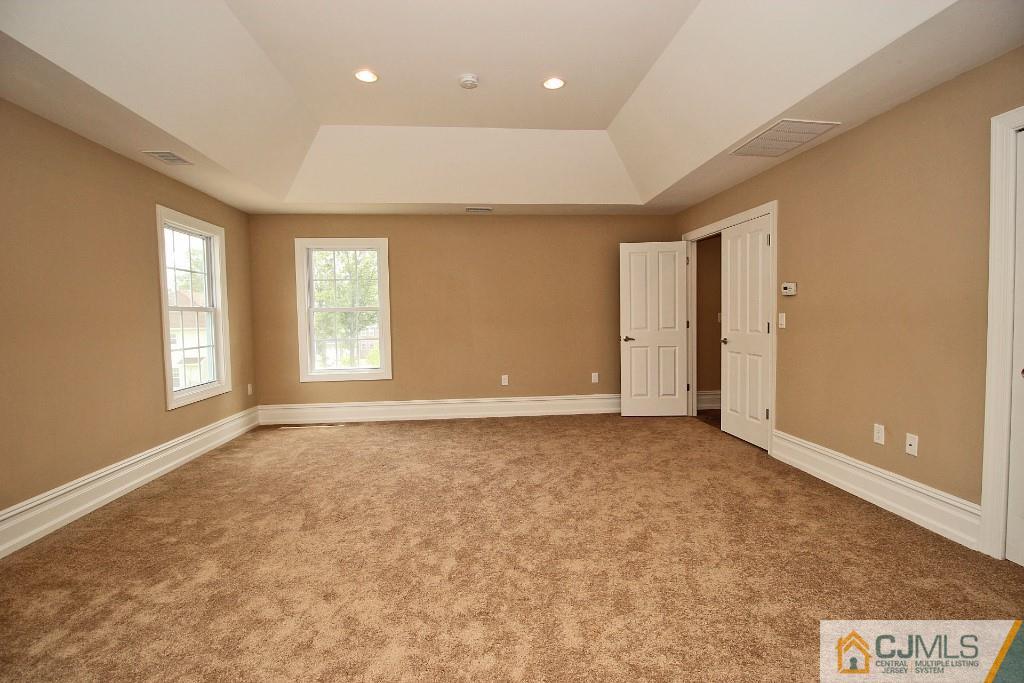 1035 New Durham Road Edison, NJ 08817 - Photo 20 of 24 an empty room with windows and closet