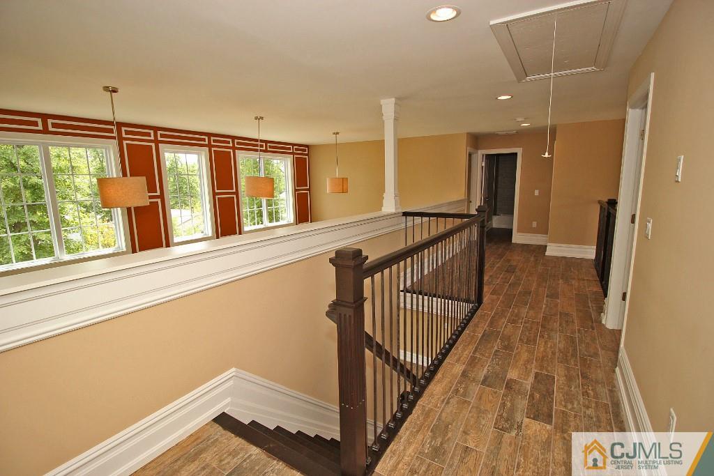 1035 New Durham Road Edison, NJ 08817 - Photo 22 of 24 a view of a hallway with wooden floor and staircase