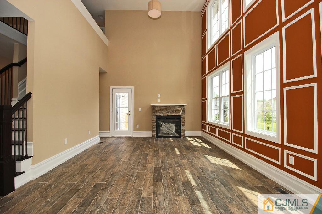 1035 New Durham Road Edison, NJ 08817 - Photo 7 of 24 a view of an empty room with a window and wooden floor