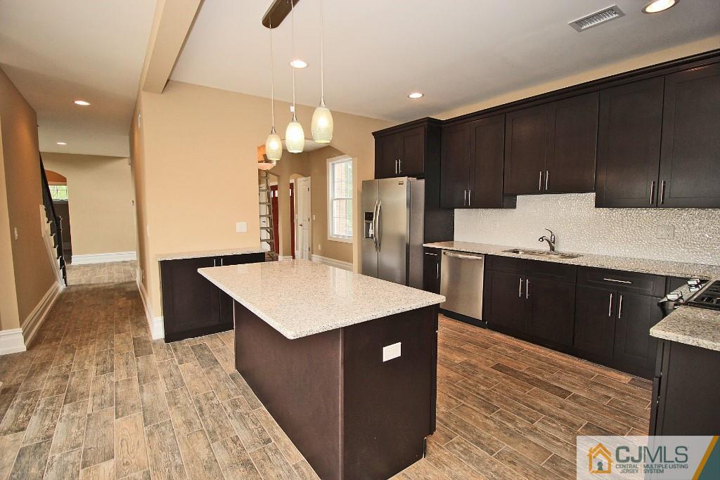 1035 New Durham Road Edison, NJ 08817 - Photo 10 of 24 a kitchen with a sink a refrigerator and a stove