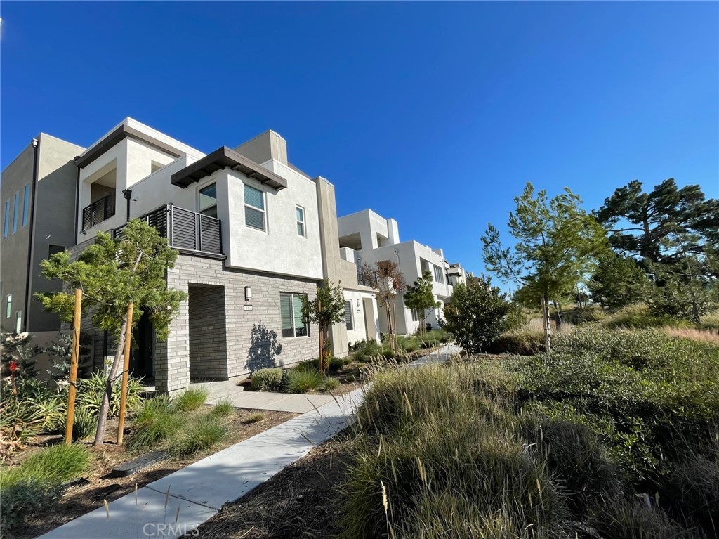 a view of a house with a small yard and plants