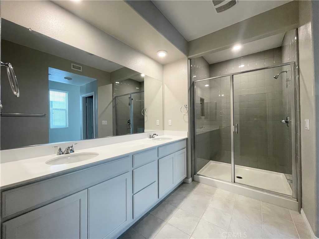 164 Spectacle Irvine, CA 92618 - Photo 11 of 21 a bathroom with a shower sink and mirror
