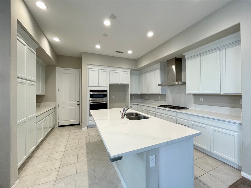 164 Spectacle Irvine, CA 92618 - Photo 5 of 21 a kitchen with a sink a stove a refrigerator and cabinets