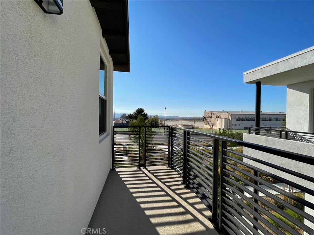 164 Spectacle Irvine, CA 92618 - Photo 10 of 21 a view of a balcony with wooden floor and outdoor seating