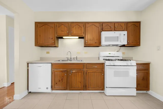 a kitchen with stainless steel appliances granite countertop a sink and a stove top oven