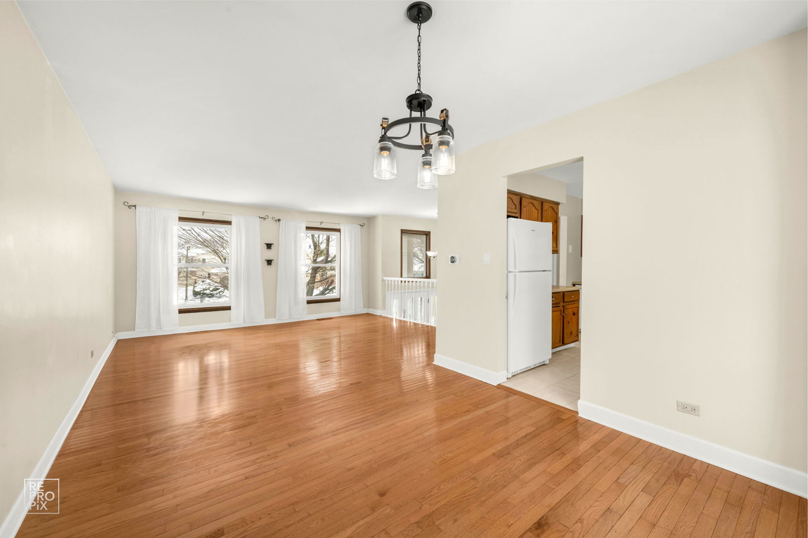 1033 Warwick Circle South Hoffman Estates, IL 60169 - Photo 5 of 18 a view of an empty room with wooden floor and windows
