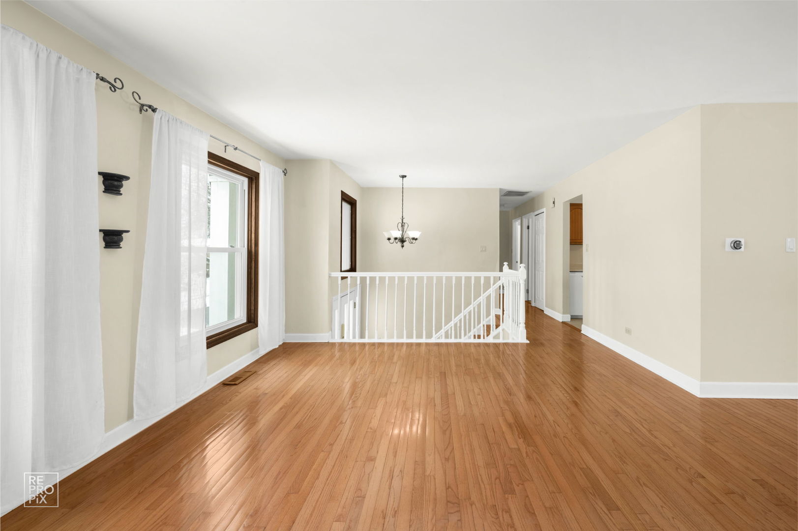 1033 Warwick Circle South Hoffman Estates, IL 60169 - Photo 6 of 18 a view of a room with wooden floor and windows