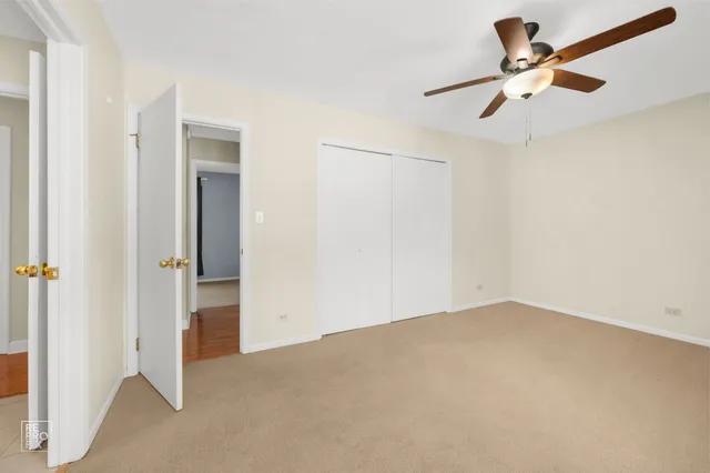 an empty room with closet and windows