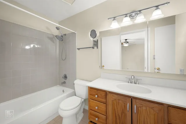 a bathroom with a sink a toilet and a large mirror