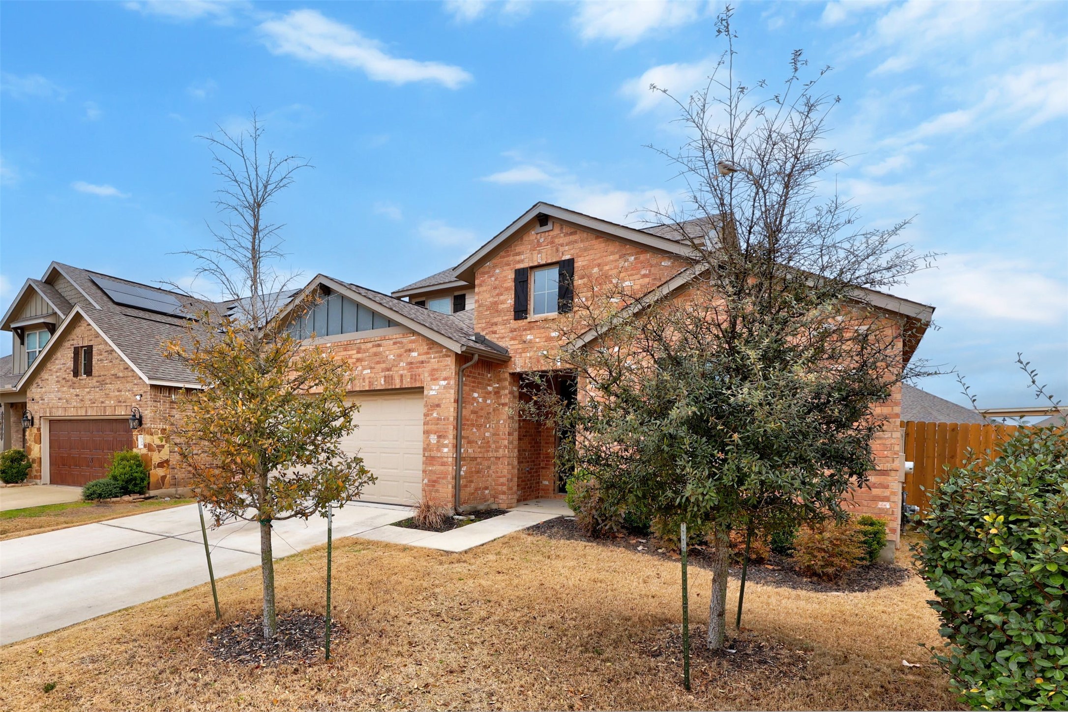 307 Simmental Loop Hutto, TX 78634 - Photo 3 of 34 Brick facade with integrated solar panels enhances this attractive modern residence.