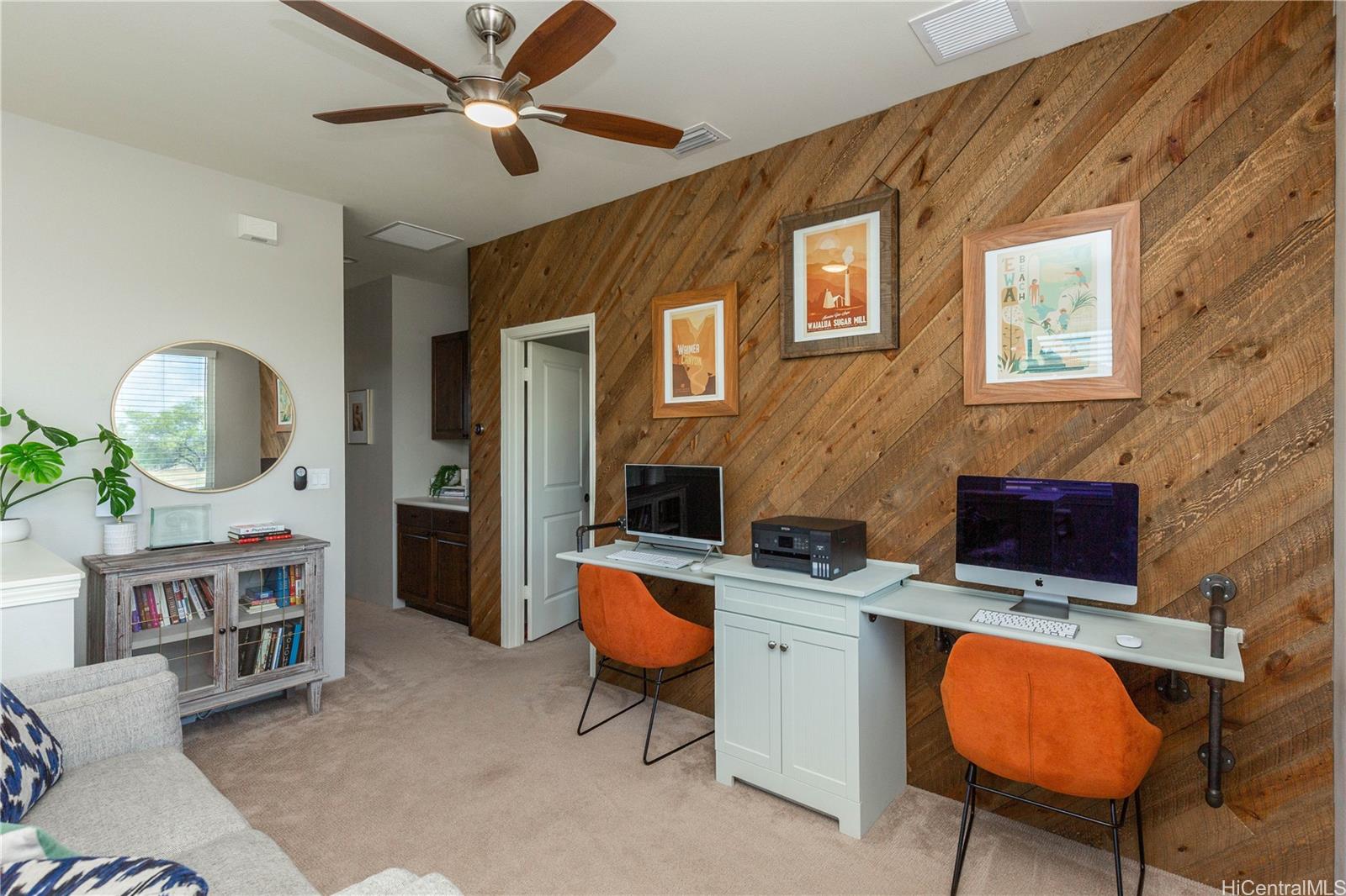 91-1077 Hokua Street Ewa Beach, HI 96706 - Photo 16 of 25 a living room with furniture a chandelier and a flat screen tv