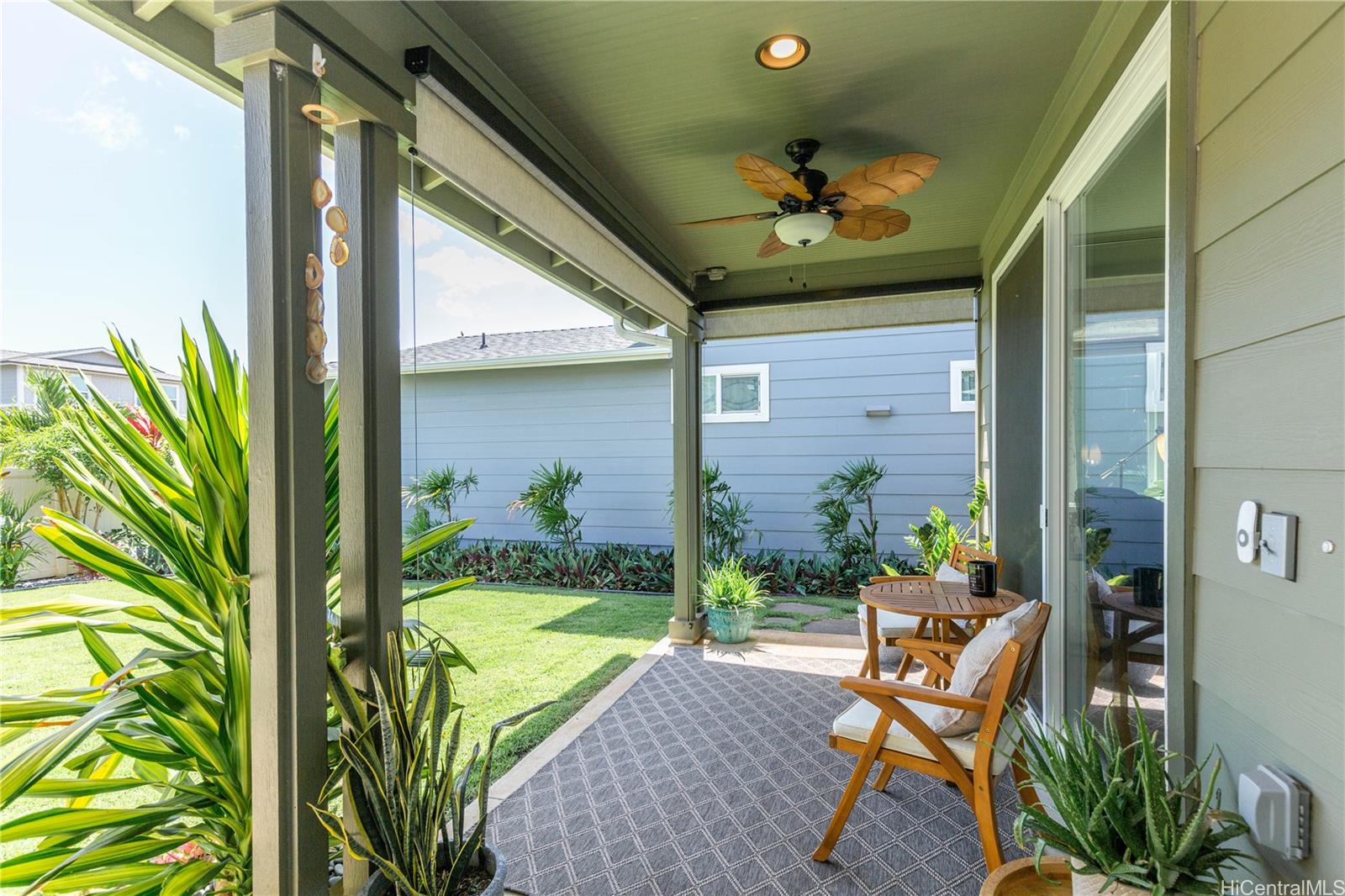 91-1077 Hokua Street Ewa Beach, HI 96706 - Photo 17 of 25 a view of a porch with chairs and potted plants