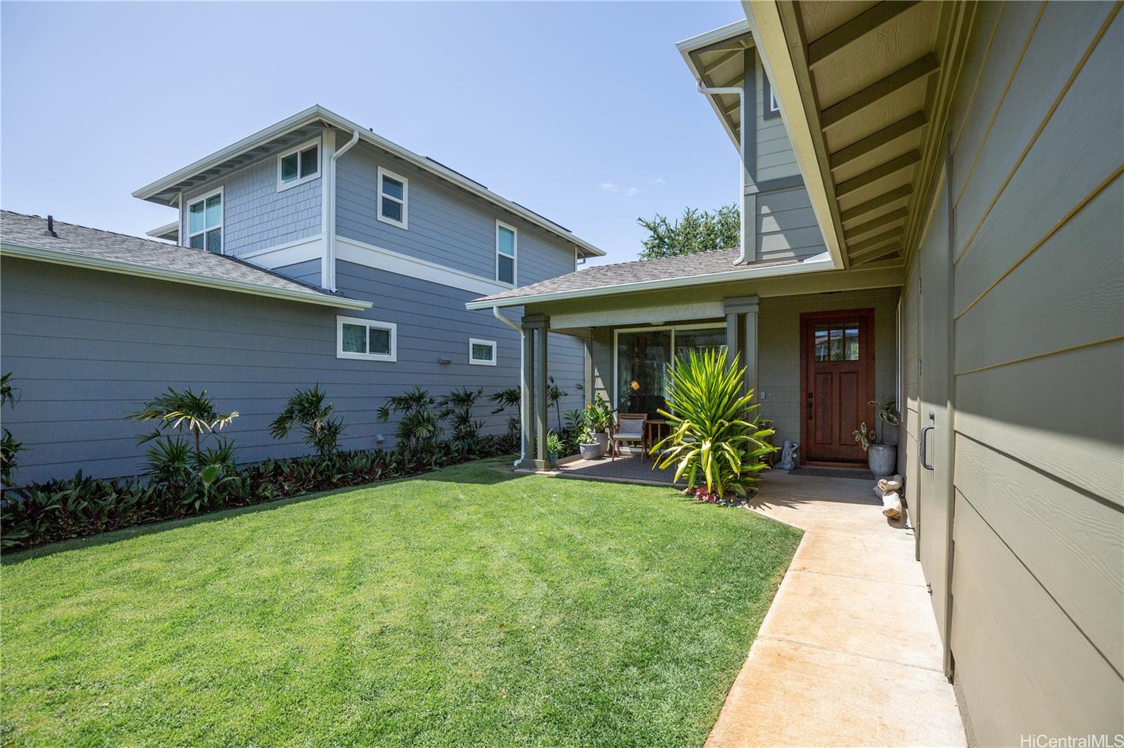 91-1077 Hokua Street Ewa Beach, HI 96706 - Photo 18 of 25 a view of a house with a small yard and plants
