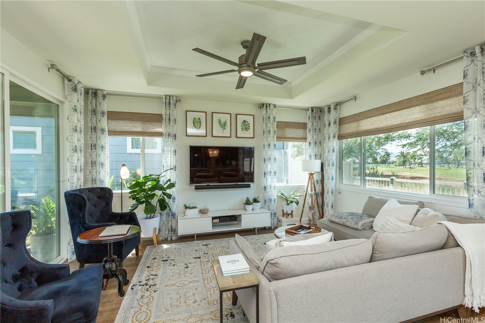 91-1077 Hokua Street Ewa Beach, HI 96706 - Photo 2 of 25 a living room with furniture a large window and a flat screen tv