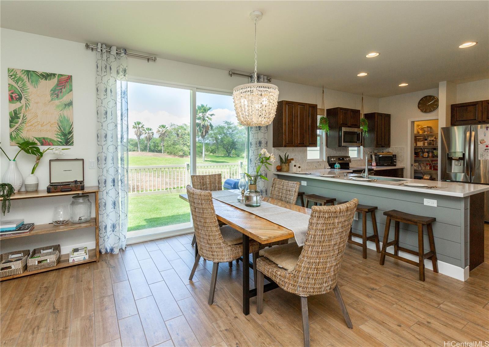 91-1077 Hokua Street Ewa Beach, HI 96706 - Photo 4 of 25 a view of a dining room with furniture window and wooden floor