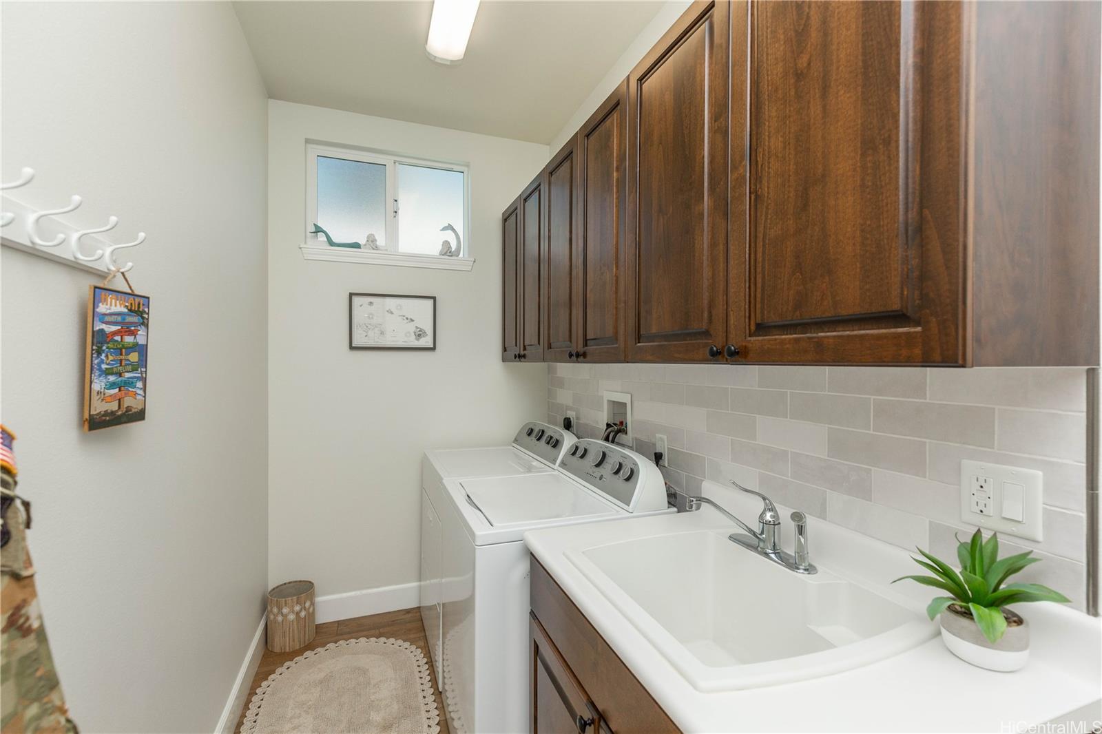 91-1077 Hokua Street Ewa Beach, HI 96706 - Photo 8 of 25 a bathroom with a sink a toilet and vanity