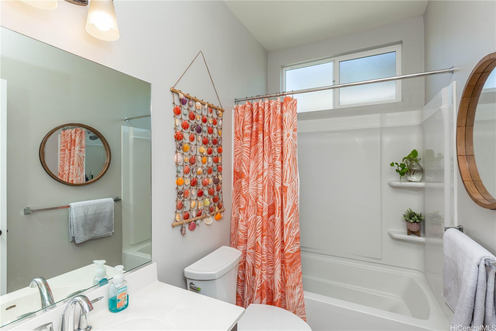 91-1077 Hokua Street Ewa Beach, HI 96706 - Photo 9 of 25 a bathroom with a toilet a sink and a bathtub