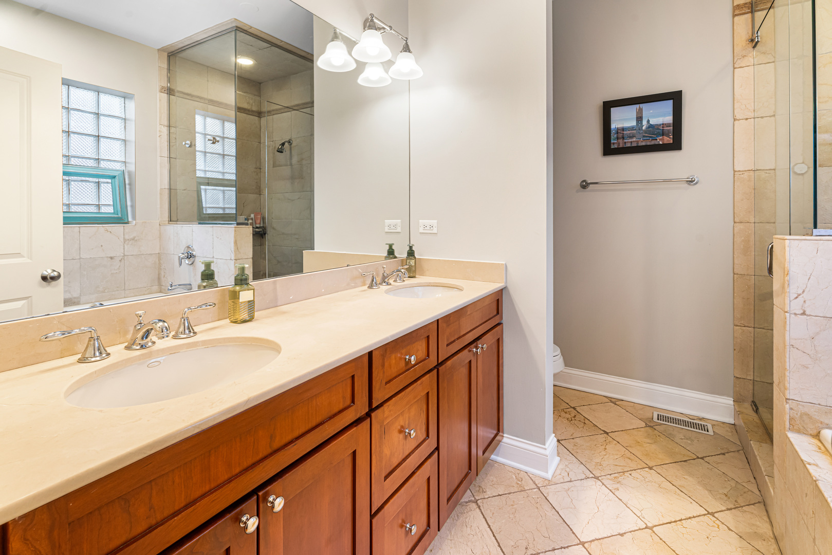 Undisclosed Address Chicago, IL 60613 - Photo 26 of 68 a bathroom with a sink a vanity and a mirror