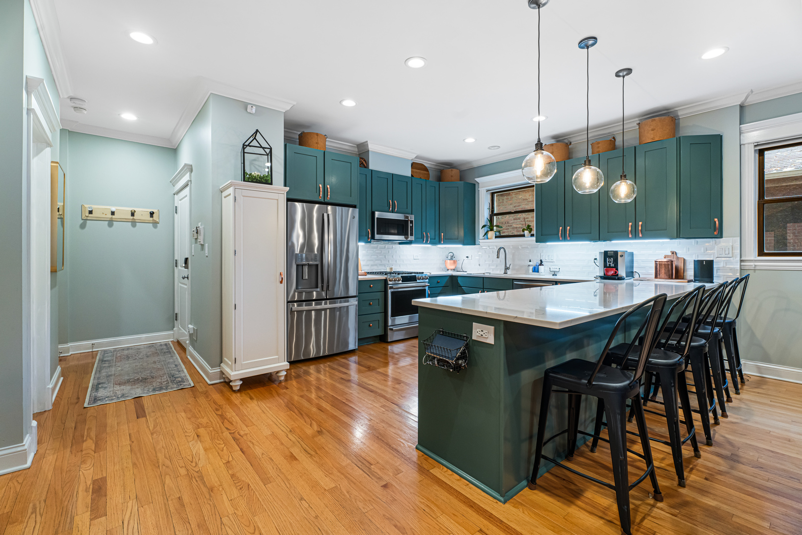 Undisclosed Address Chicago, IL 60613 - Photo 4 of 68 a kitchen with stainless steel appliances granite countertop a refrigerator a sink and a stove top oven