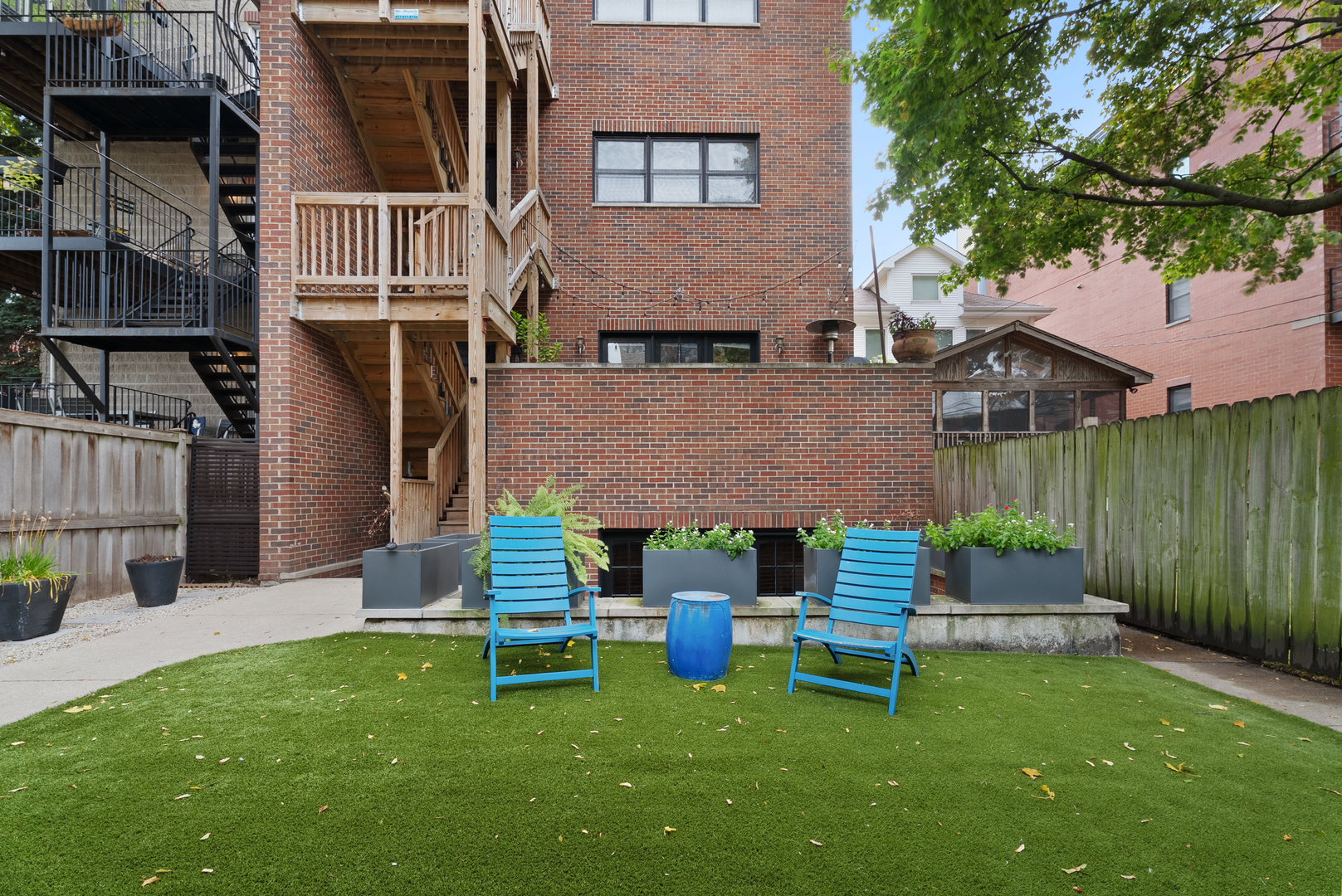 Undisclosed Address Chicago, IL 60613 - Photo 54 of 68 a front view of a house with a garden and outdoor seating