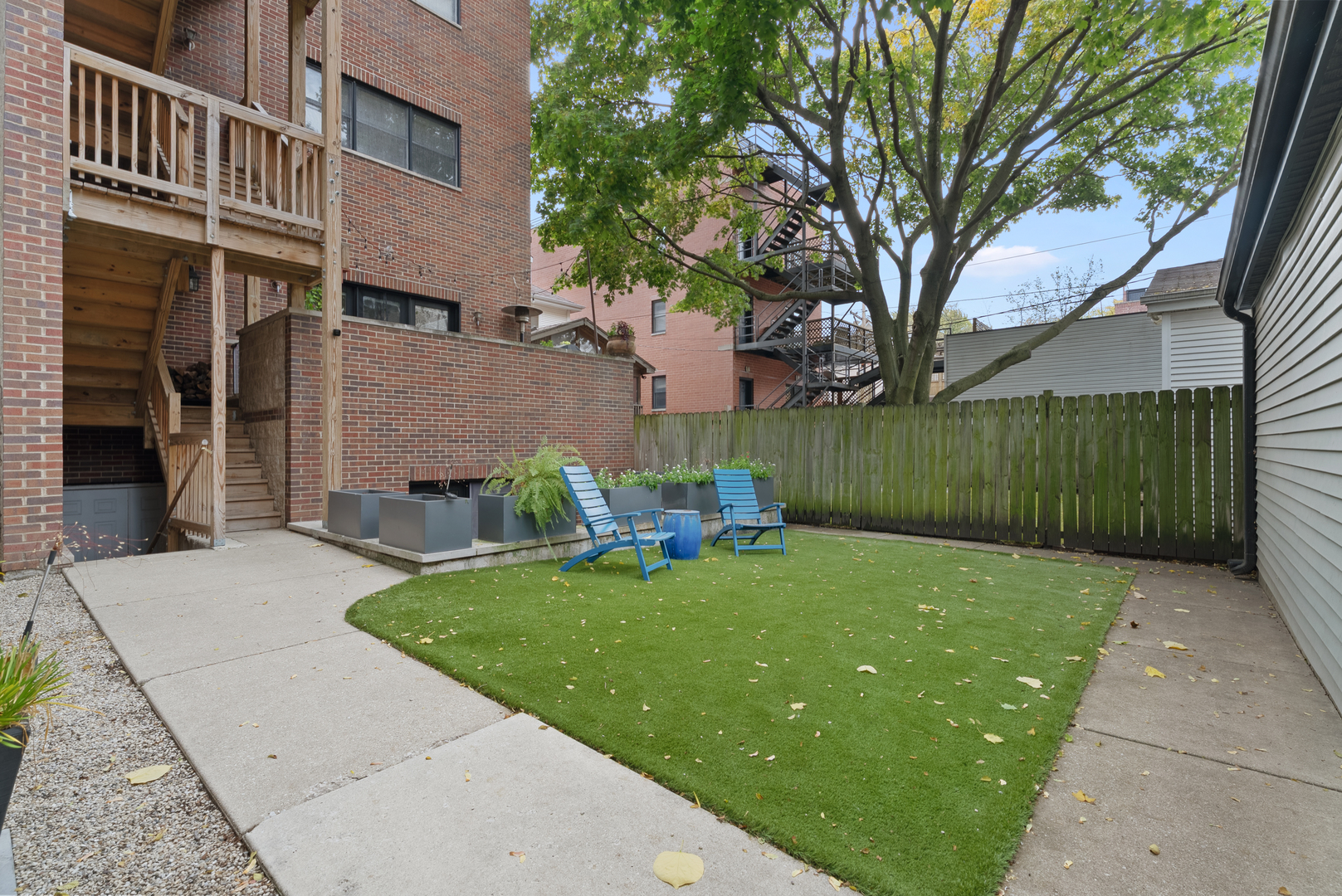Undisclosed Address Chicago, IL 60613 - Photo 55 of 68 a view of backyard with table and chairs and wooden fence