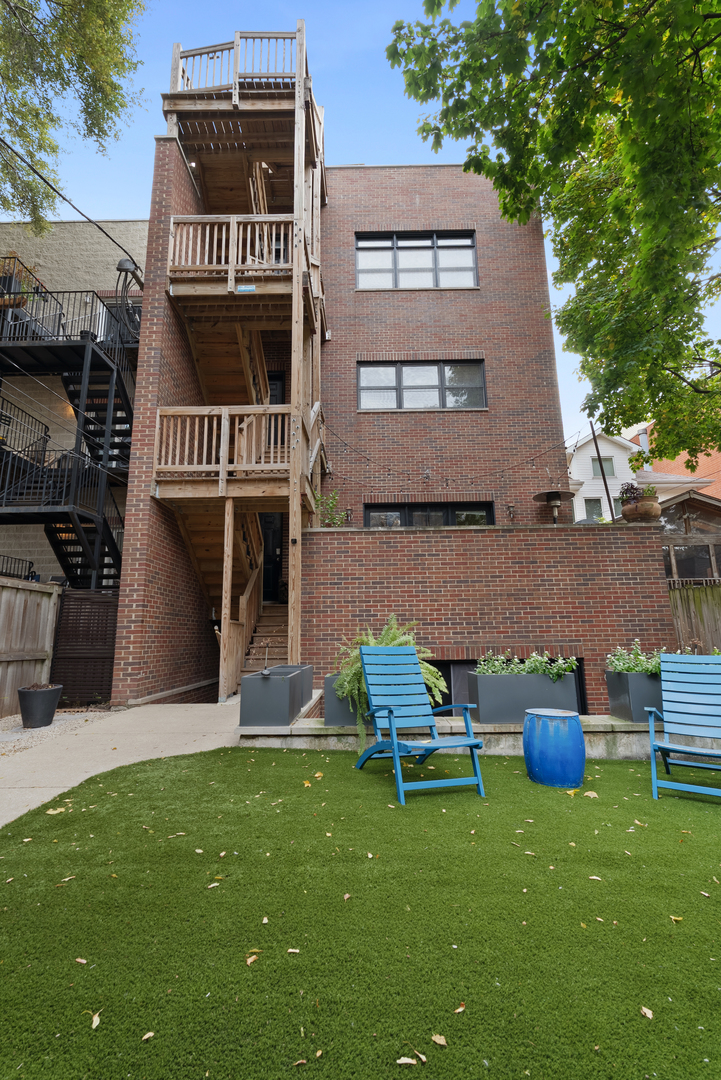 Undisclosed Address Chicago, IL 60613 - Photo 57 of 68 a front view of a house with a yard