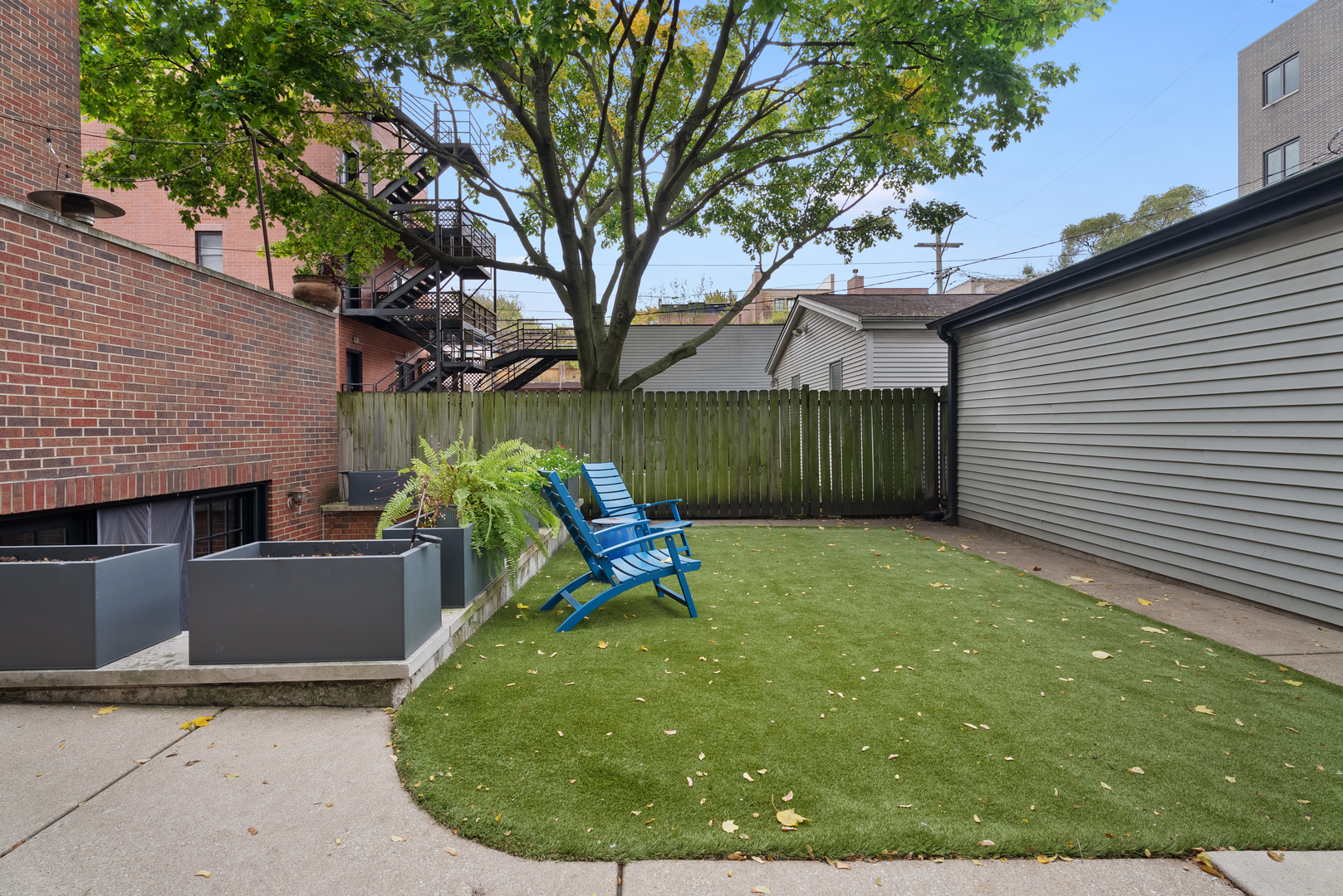 Undisclosed Address Chicago, IL 60613 - Photo 61 of 68 a view of a backyard with a small cabin and a fire pit