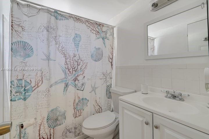 2145 Pierce Street, Unit 326 Hollywood, FL 33020 - Photo 16 of 37 a bathroom with a sink toilet and shower
