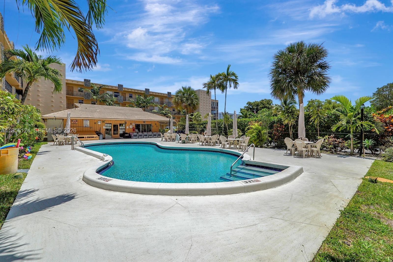 2145 Pierce Street, Unit 326 Hollywood, FL 33020 - Photo 22 of 37 a view of a swimming pool with a patio
