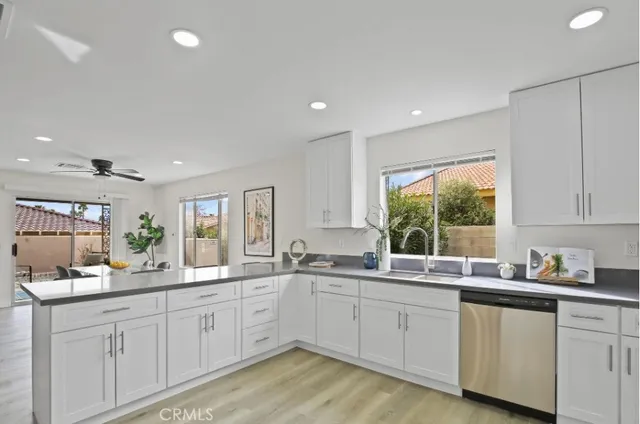 a kitchen with sink a window and cabinets