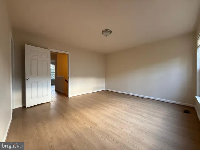 a view of an empty room and wooden floor
