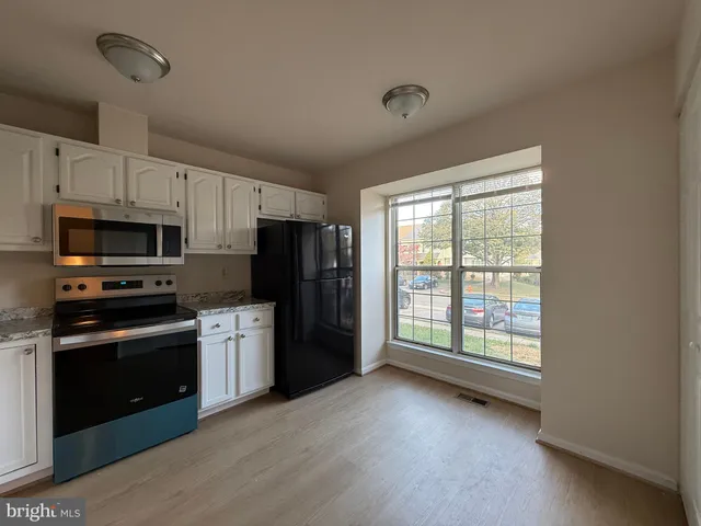 a kitchen with stainless steel appliances a stove sink and refrigerator