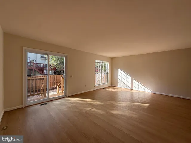 a view of an empty room with glass door