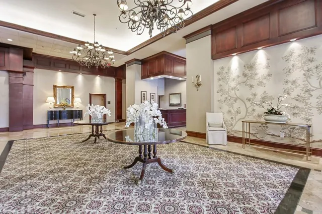 a living room with fireplace furniture and a large window