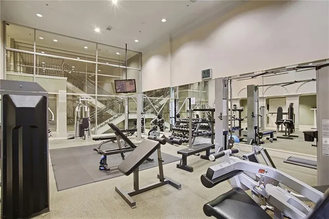 a living room with furniture a flat screen tv and pool table