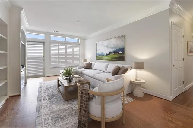 a living room with furniture and wooden floor