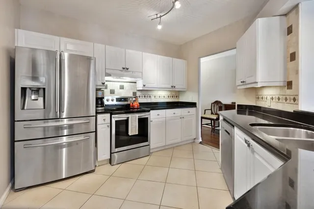 a kitchen with granite countertop a stainless steel appliances cabinets and a counter top space